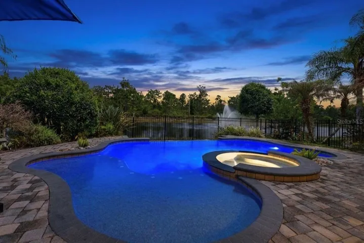 Evening at the pool with pool and spa lights on