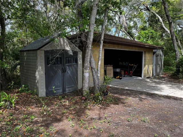 A storage shed on each side of garage.