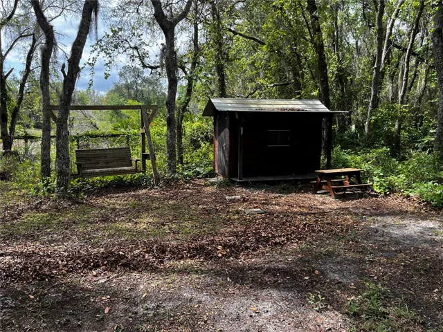 Relax in the swing while the kids play in the playhouse!