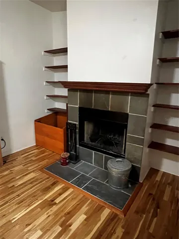 Wood-burning fireplace with firebox in living room, which is 29'4