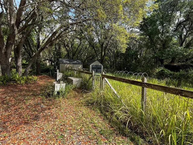 30' x 50' Fenced in raised bed area with two storage sheds, irrigation and washing sink.