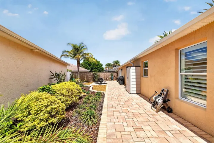 Spacious Side Paver Patio with Enhanced Stoned Hardscaping