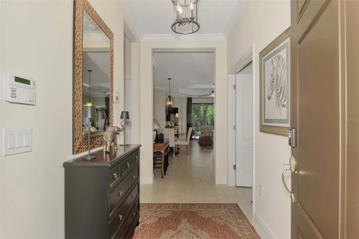 Gracious entry with crown molding and decorative foyer light.