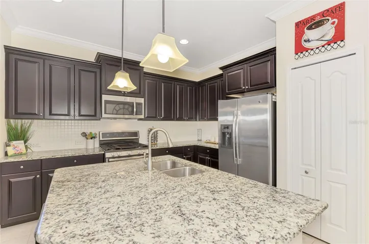 Large Kitchen Island with Pendant lighting, pantry.