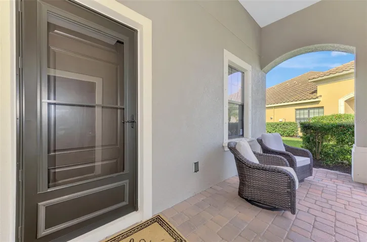 Covered front porch with pavers and sitting area