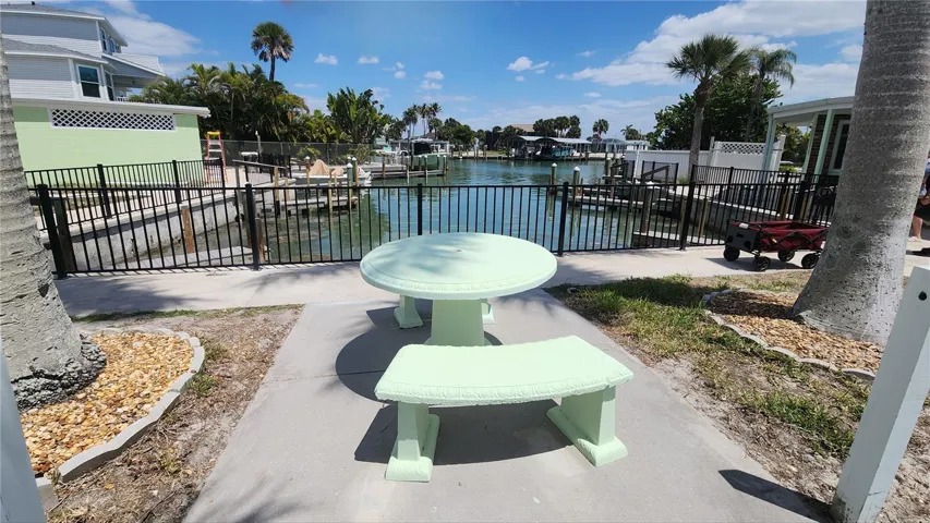 CEMENT TABLE OVERLOOKING THE WATER FOR YOUR CONVENIENCE
