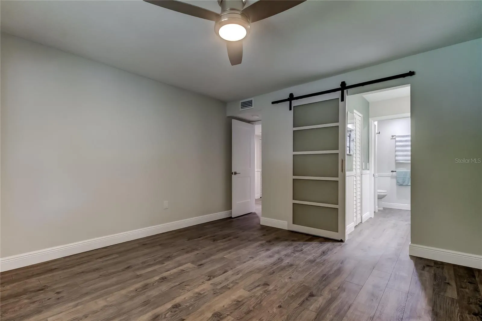 Owner's Retreat Bedroom.. Modern Sliding Door to En Suite Bath &amp; Cali Style Built Out Walk in Closet.