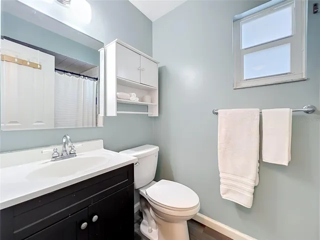 Primary bathroom with standing shower & vanity