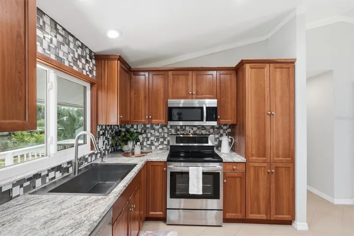 Stainless Sink, granite-look Formica Countertops and Closet Pantry. Pull outs in all lowers and Pantry.