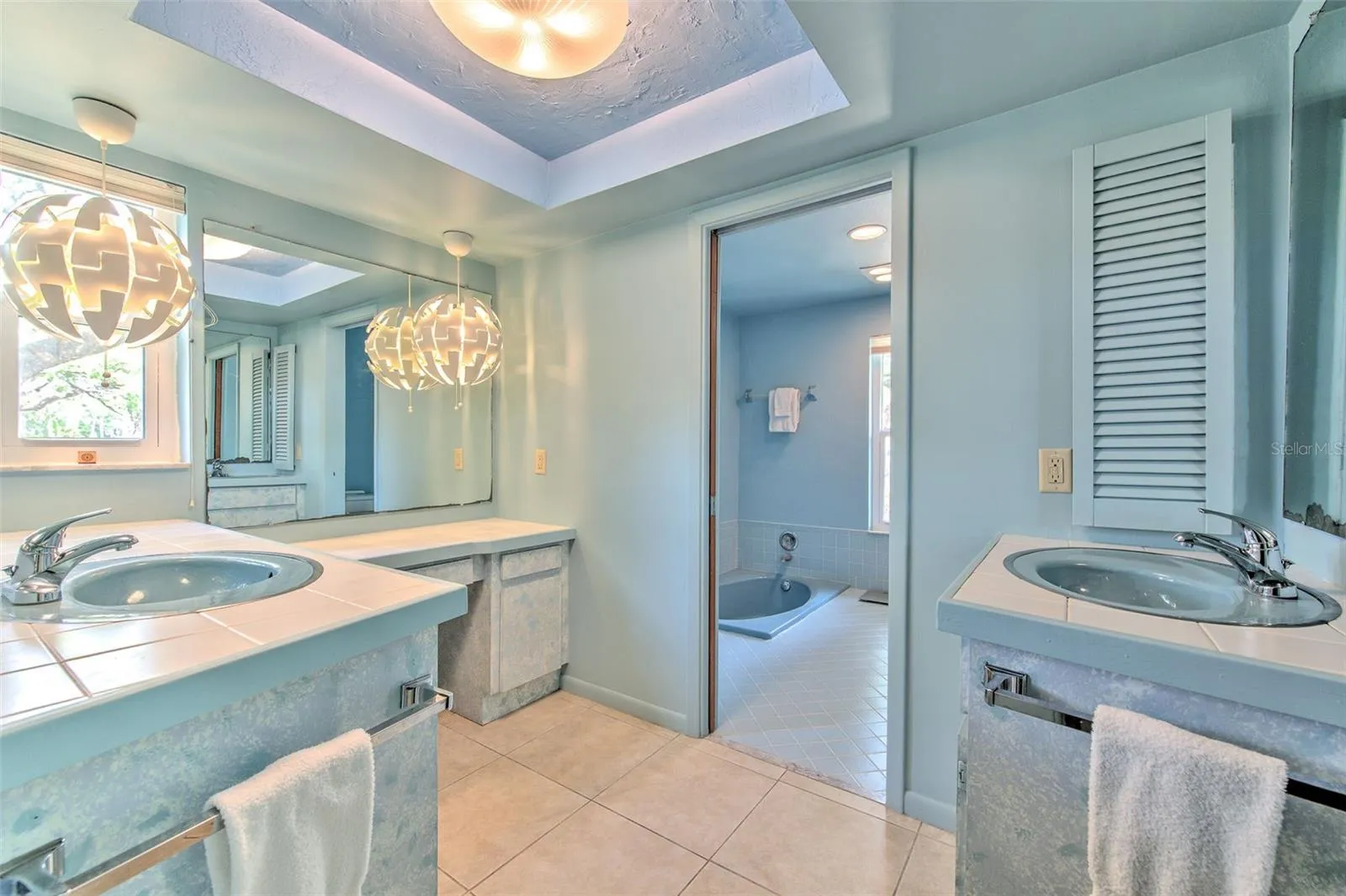 Master enSuite bathroom  with separate dual sink vanities and makeup vanity area