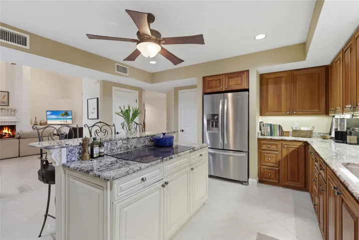 Kitchen with center island cooktop, walk-in pantry and abundant cabinetry