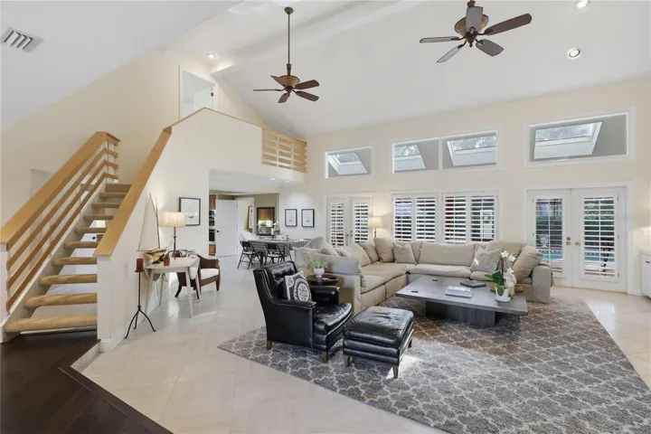 Expansive great room with soaring ceilings, skylights, and abundant natural light