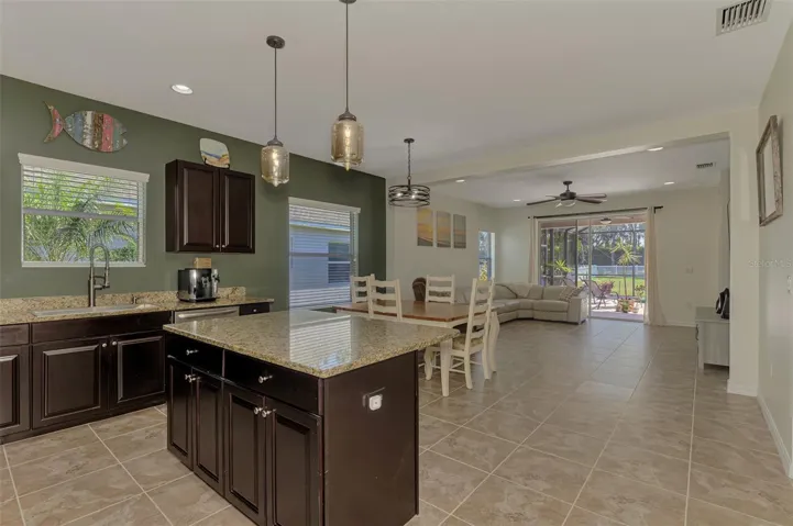 Large eat-in kithen island with views to living room, pool area and over-sized back yard.