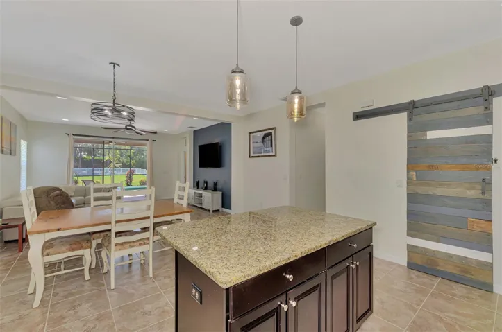 Long-range views from kitchen through Living Room to Over-sized FENCED backyard with POOL.