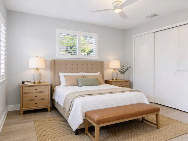 AI Enhanced photo. A spacious master bedroom with plenty of light and and en-suite bath.