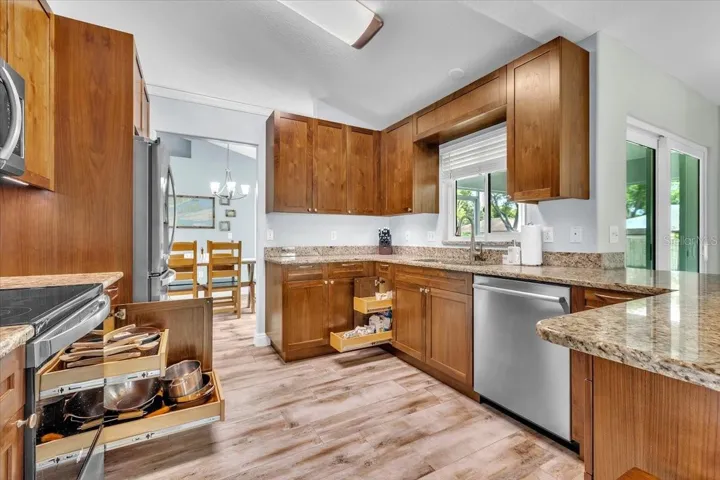 Storage and organized walnut cabinets and drawers throughout kitchen