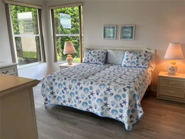 Primary Bedroom with sliders leading to lanai and views of the pond