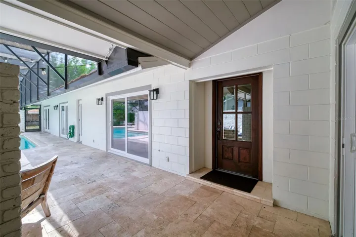 Travertine tile surrounding pool and patio