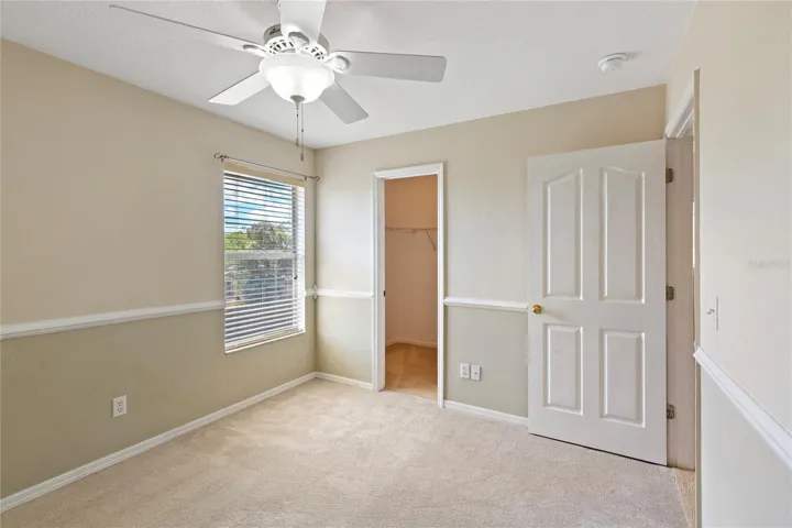 Walk in closet and ceiling fan.