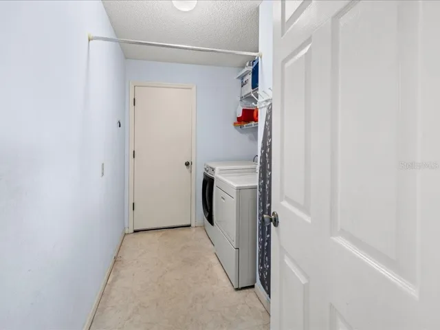 INSIDE LAUNDRY ROOM WITH ACCESS TO THE GARAGE.