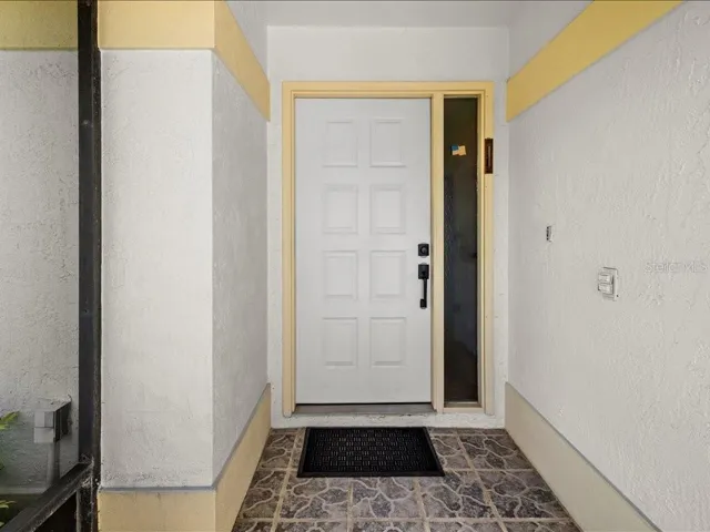 THE COVERED FRONT ENTRY IS FULLY SCREEN AND HAS A TILE FLOOR.