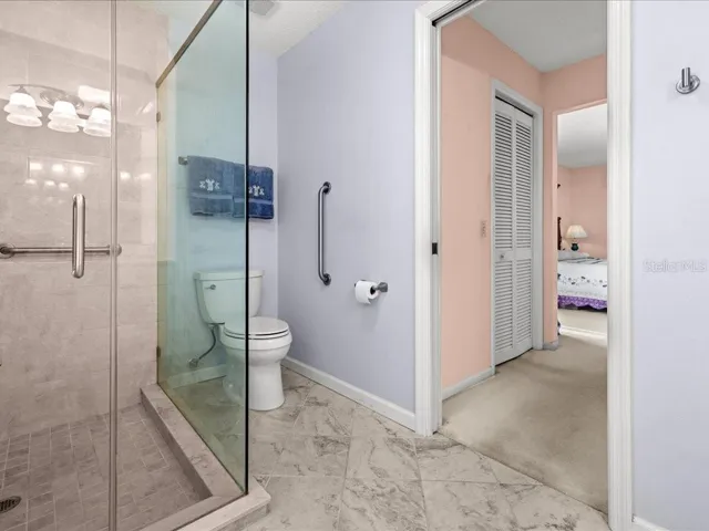 ANOTHER VIEW OF THE PRIMARY BATHROOM TOWARD THE CLOSET AREA.