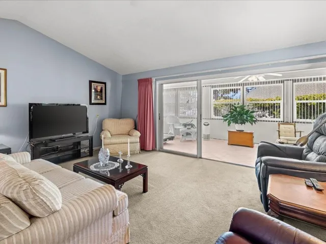 LIVING ROOM OPENS INTO A YEAR ROUND FLORIDA ROOM.