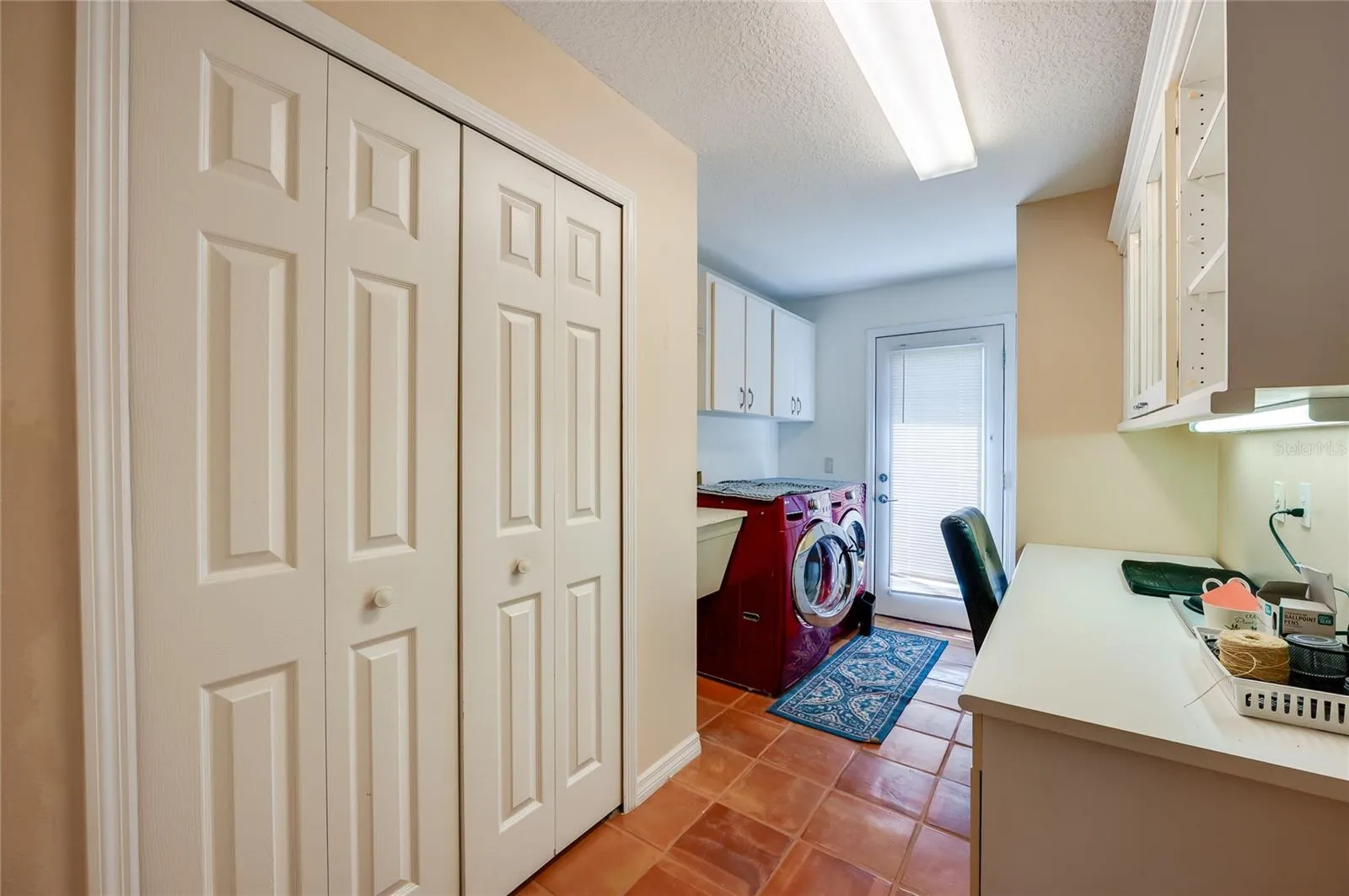Large laundry room with laundry sink and desk area