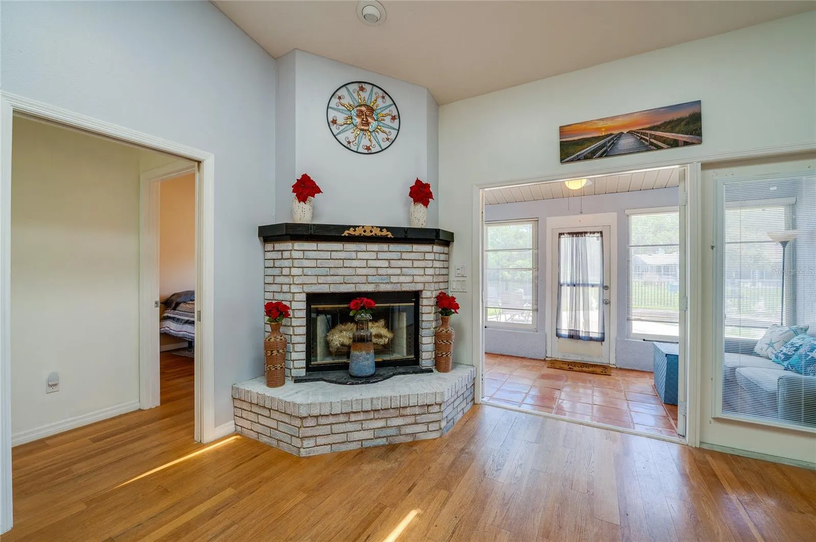 Wood-burning fireplace, French doors open to Florida room