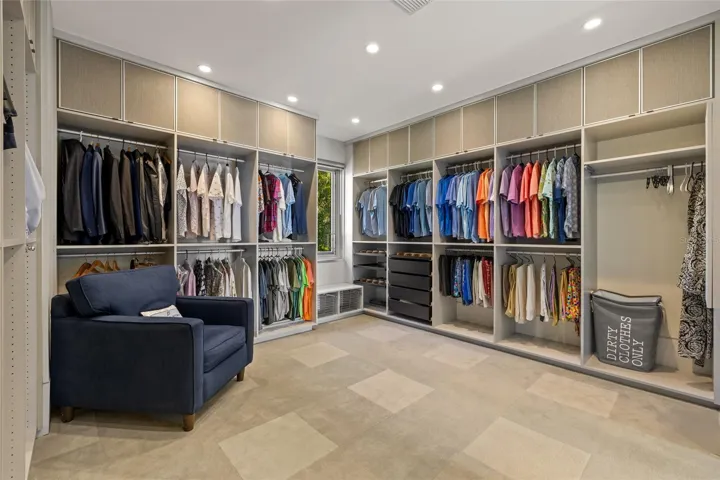Oversized walk-in closet designed with boutique-style organization