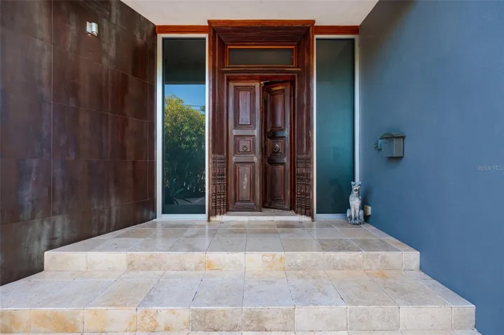 Elegant front entrance with custom double doors and refined architectural detailing
