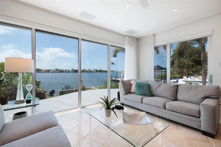 Elegant living space with seamless indoor-outdoor waterfront views