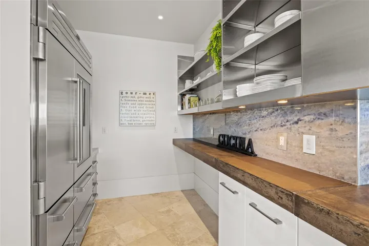 Dedicated prep area with open shelving, custom counters, and Sub Zero refrigeration & freezing.