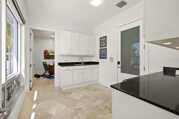 Laundry Room with Sink and folding areas. Bonus Room beyond.