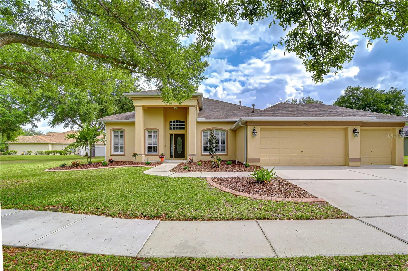Spacious driveway leading to a 3-car garage.
