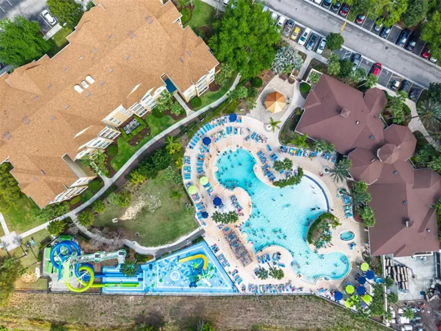 Areial_showing_community_water_slide_pool_with_clubhouse_to_right_with_dark_brown_roof