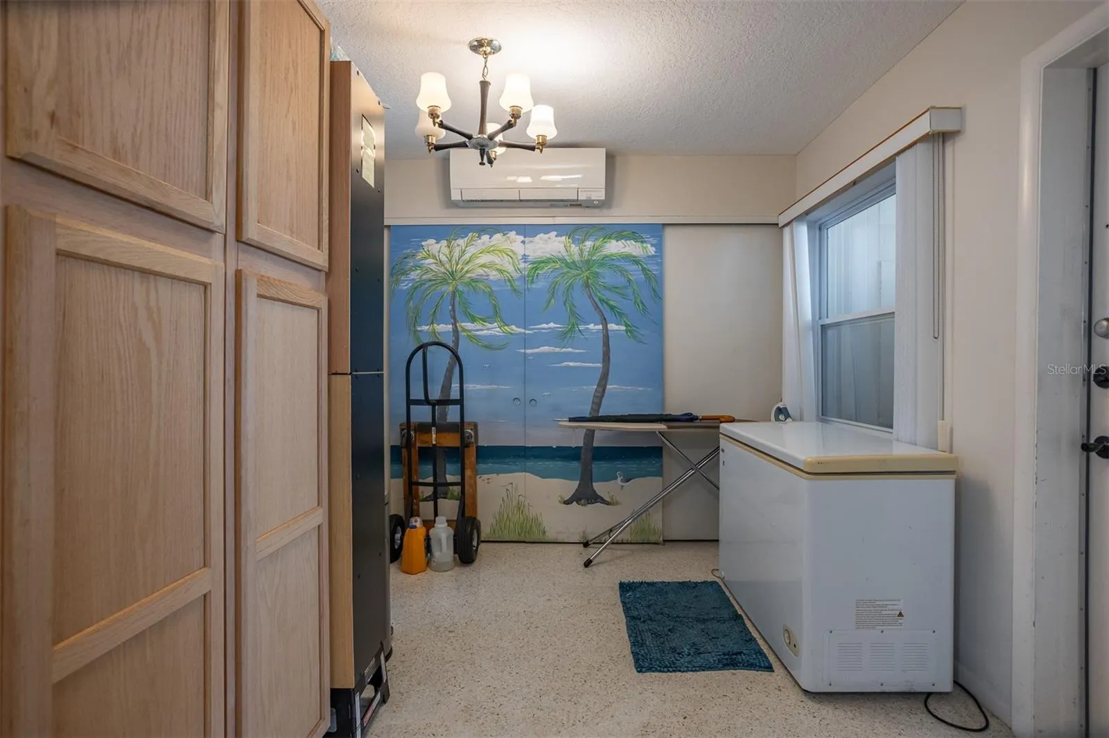 Storage area with washer and dryer just off kitchen
