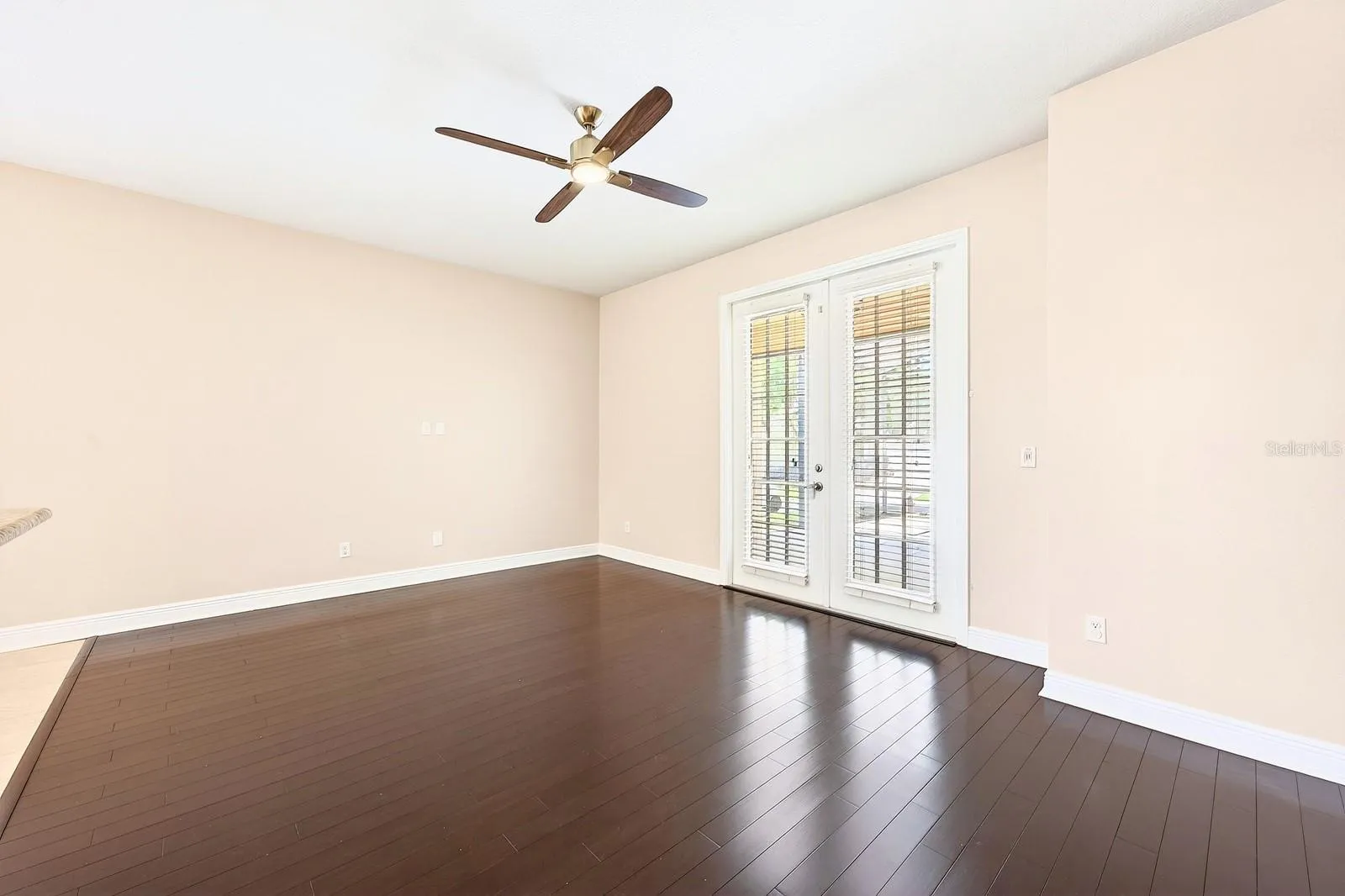 Family room has French doors that open up to the screened lanai.