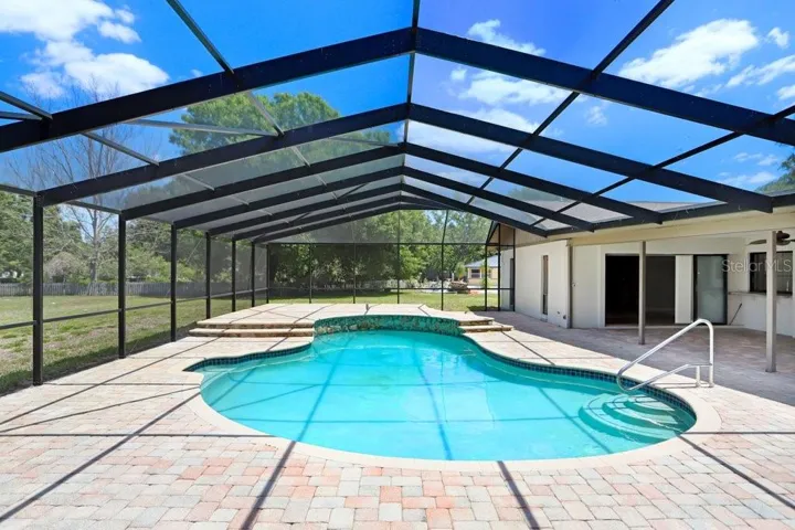 Beautiful pavers around the pebble tech pool and new pool cage
