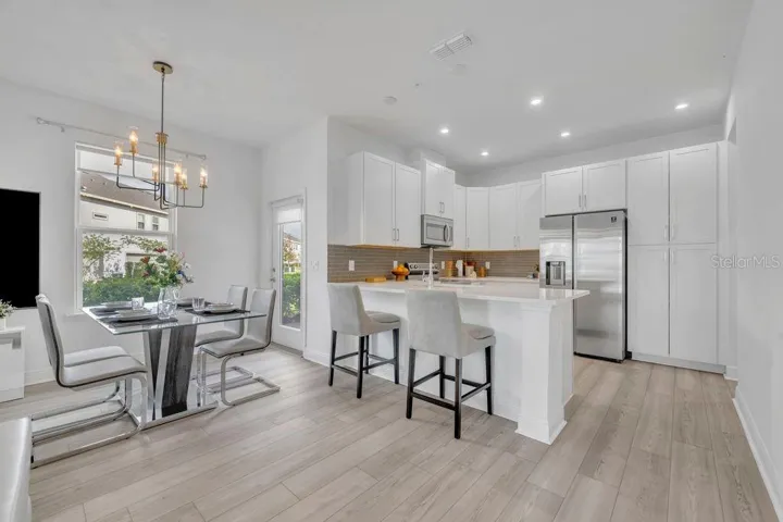 Upgraded kitchen with quartz countertops and tile backsplash