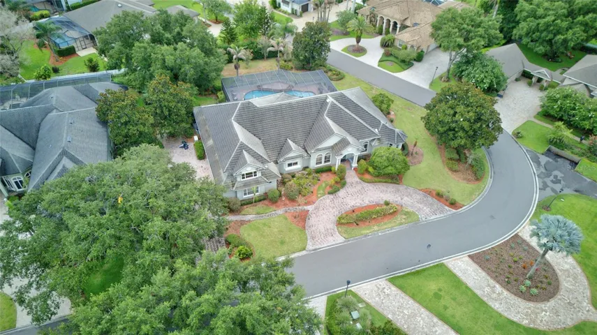 Front elevation- circular drive & boat ramp across the street on Lake Winterset, the Chain of Lakes