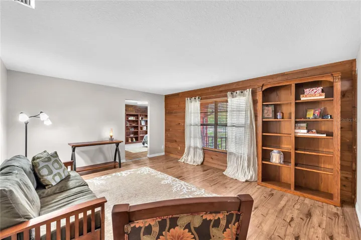 This flexible living space is the perfect setup for an in-law suite or private guest retreat, with access to a bedroom and full bathroom featuring a step-in shower and a large walk-in closet—ideal for multi-generational living.