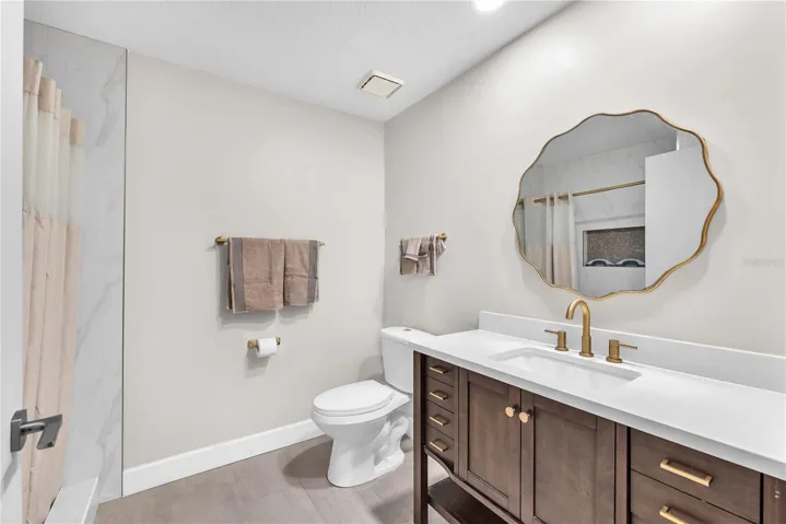 Full bathroom ensuite with step-in shower with direct access to first floor bedroom next to the flexible living space behind the rench doors.