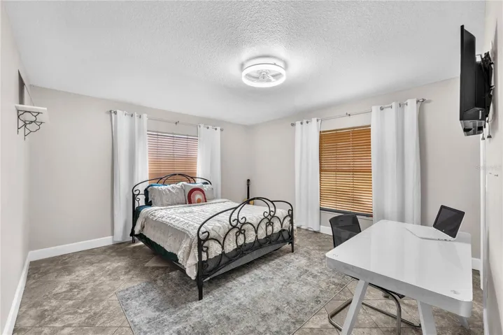 There is a second bedroom downstairs with a walk-in closet and access to another bathroom with step-in shower.