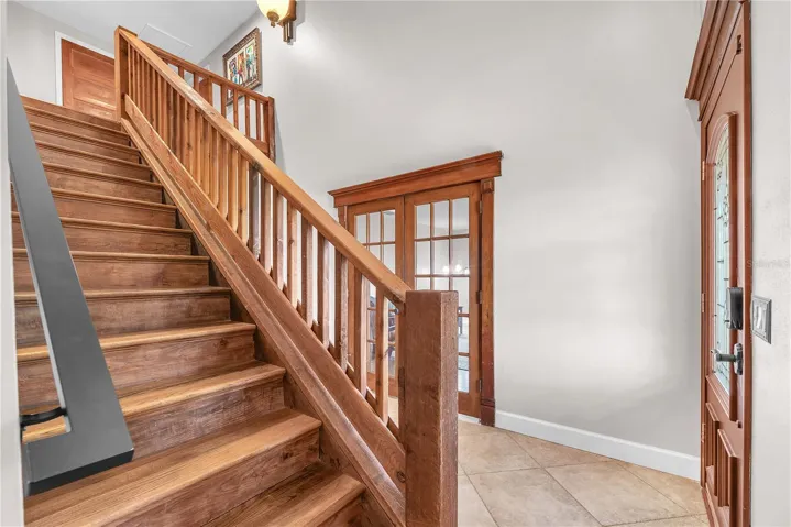 Just inside the front door there is an office or Den on your left and an additional room and bedroom suite beyond behind the french doors on the right.