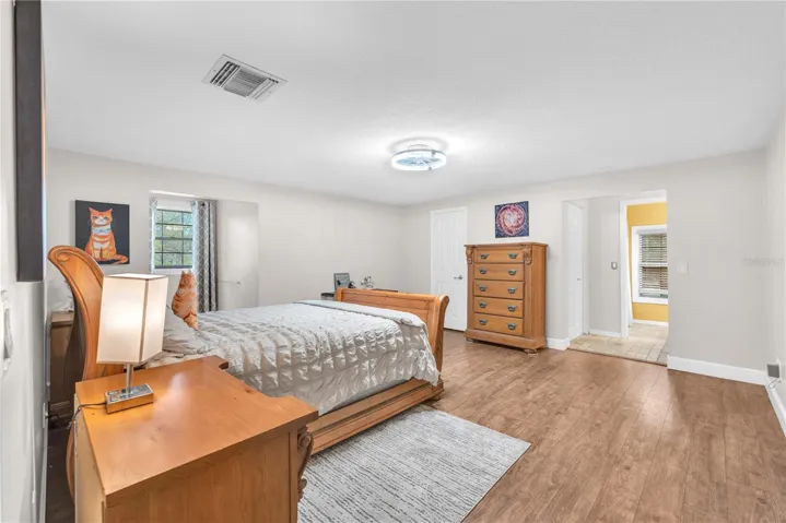 Secondary bedroom upstairs with large walk-in closet and ensuite bathroom.