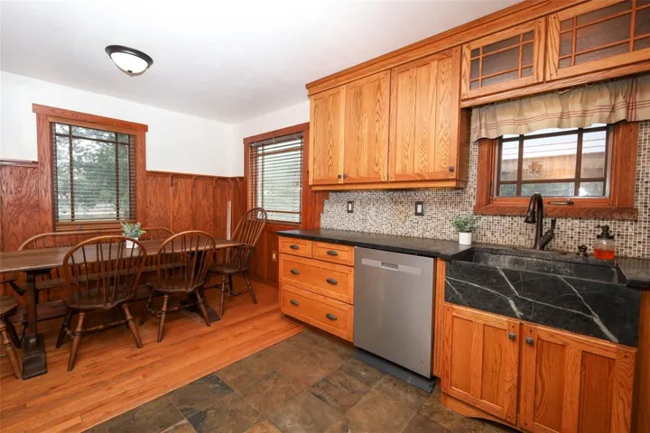 All wood cabinets with soapstone countertops and farmhouse style sink