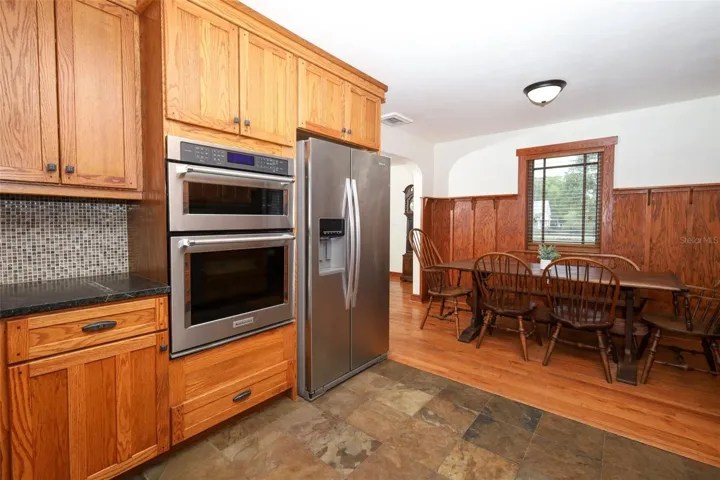 All wood cabinets with soapstone countertops and stainless steel appliances
