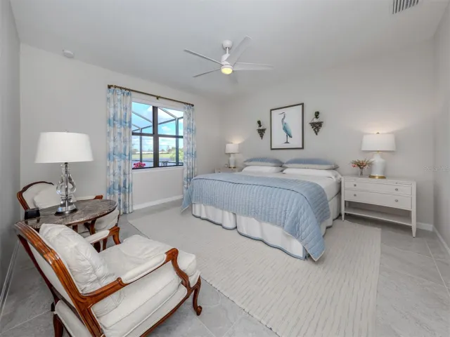 Primary bedroom with views to the pool and lake.