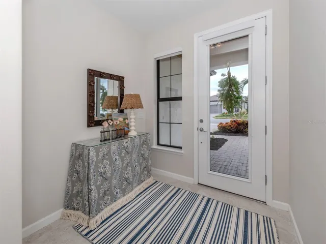 Entryway with fullview impact glass front door.  Solar shade for privacy and sun protection.